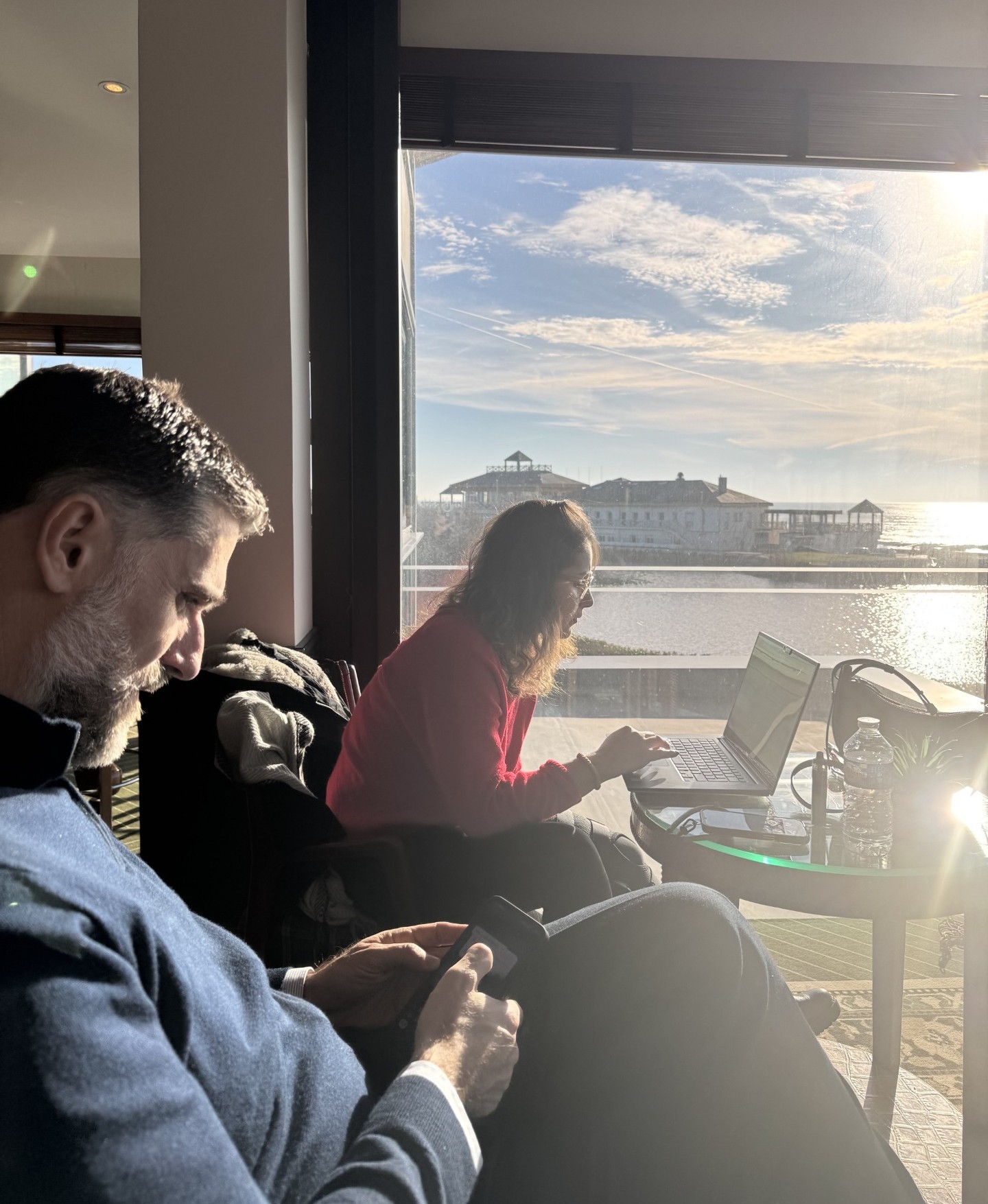 The Synapture team working remotely by the sea